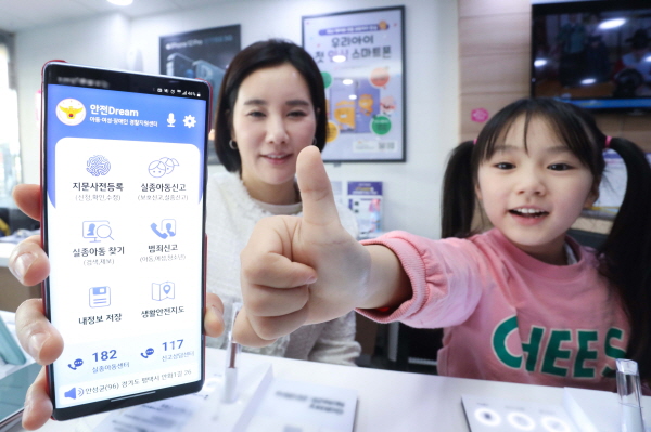아이와 엄마가 LG유플러스 매장에서 경찰청 안전드림 앱으로 지문등 사전 등록을 하고 있다.